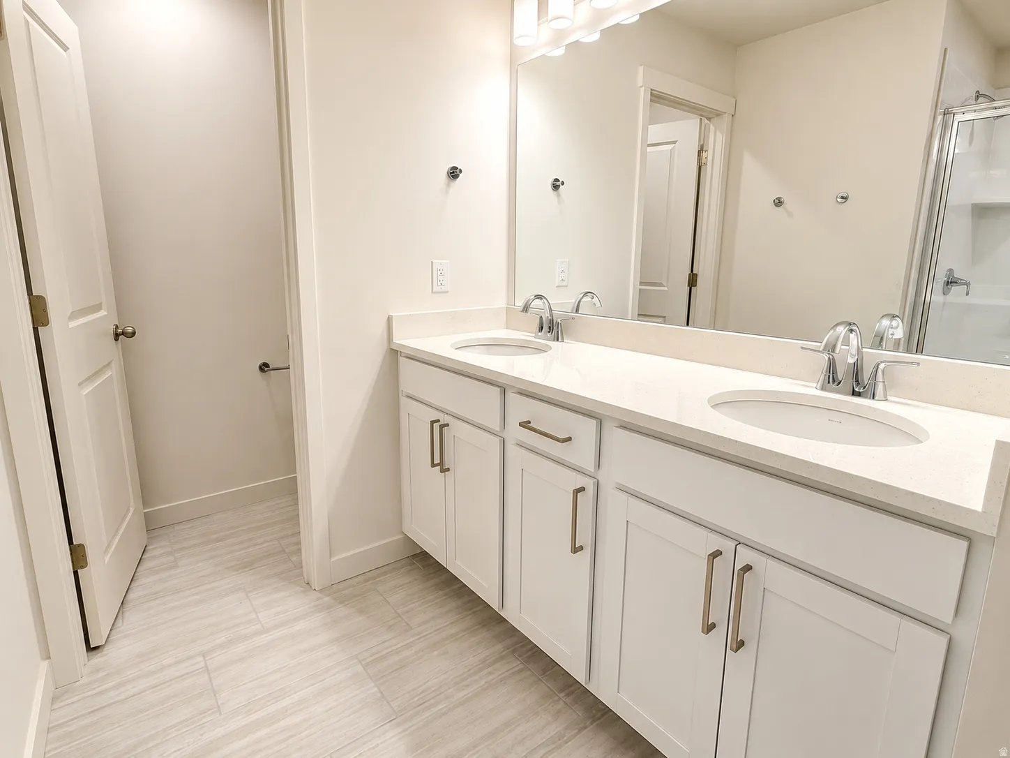 Primary bathroom with 2 sinks and a large walk in shower.