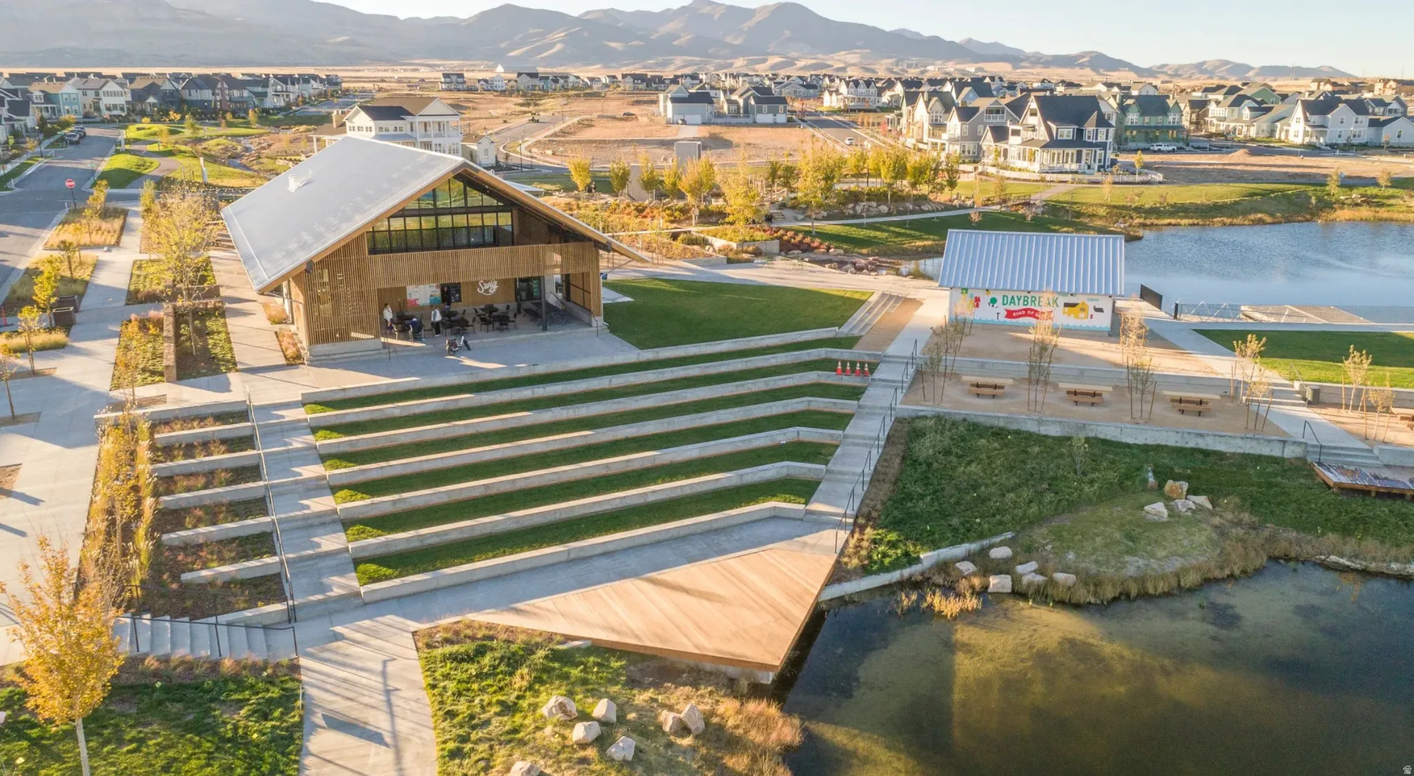 Wood-sided community building with a metal roof and expansive window features