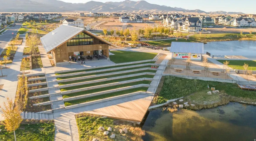 Wood-sided community building with a metal roof and expansive window features
