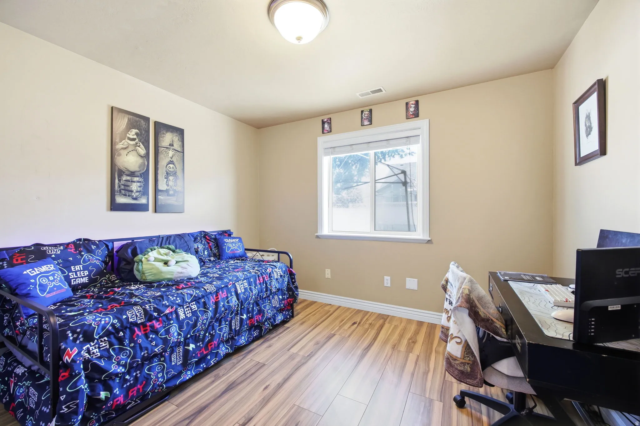 Room featuring wood-finish flooring, a double-pane window, and a ceiling-mounted light fixture