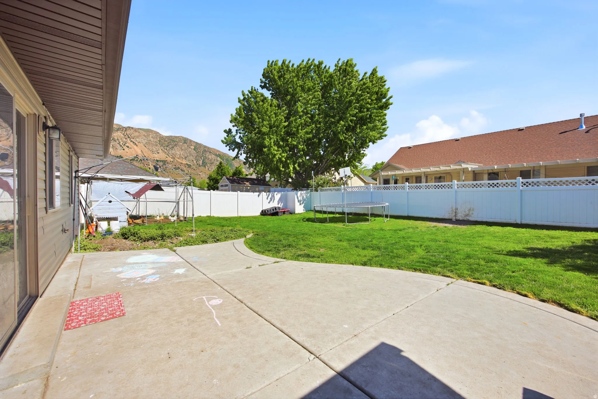 Expansive concrete patio with direct access to a manicured lawn