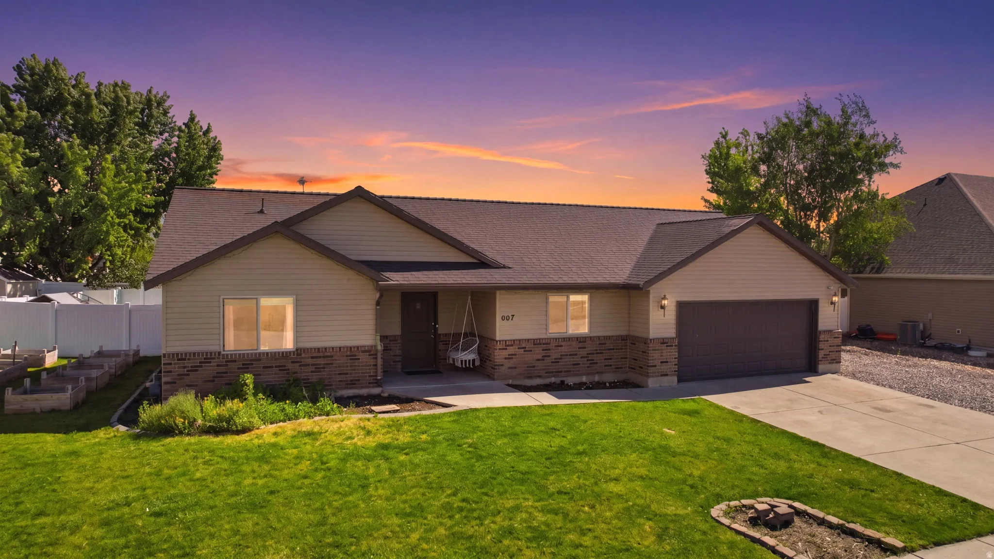 Ranch-style exterior featuring a dark brown shingle roof, beige siding, and a brick veneer wainscoting