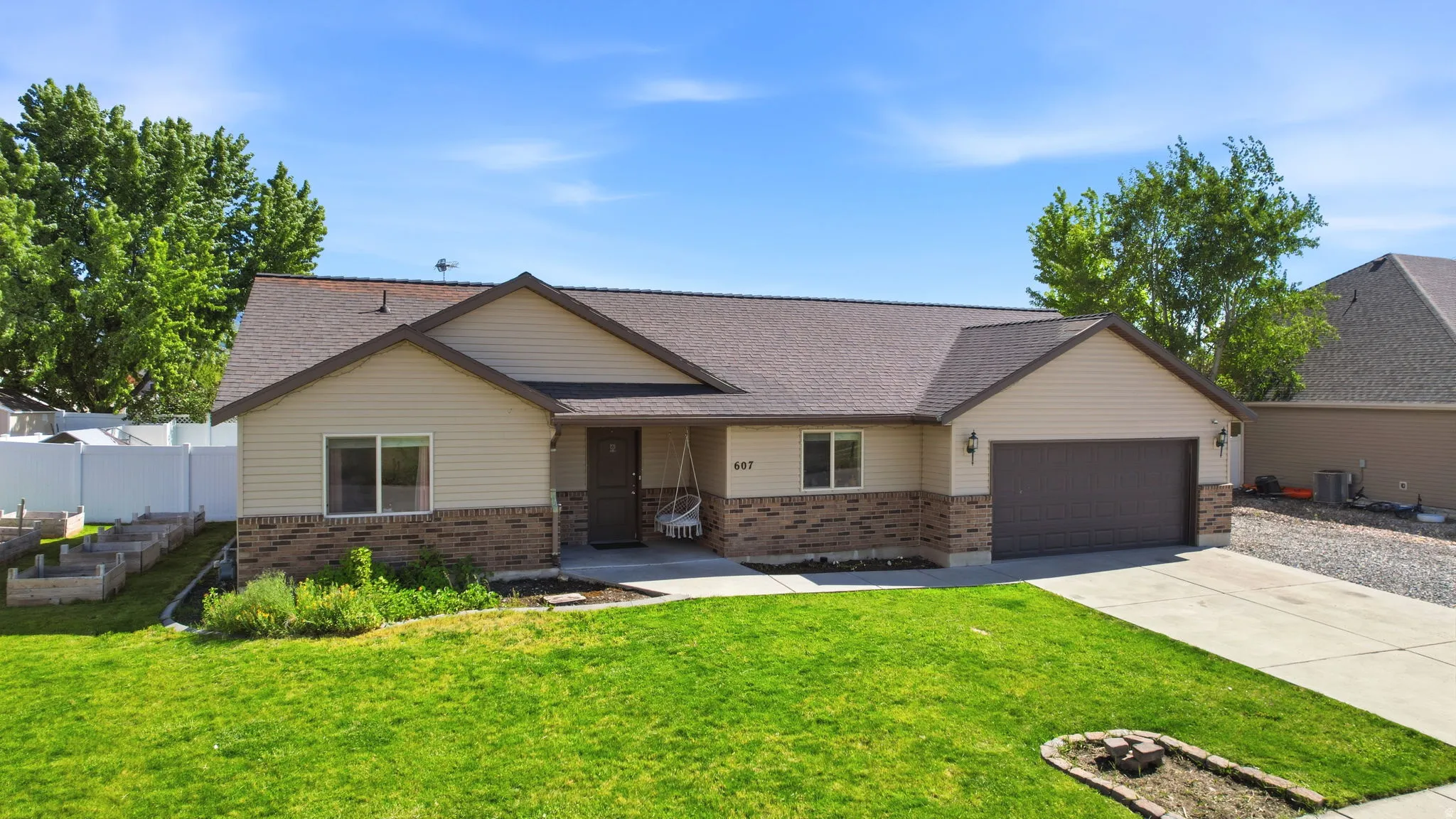 Ranch-style exterior with beige siding and brick accents