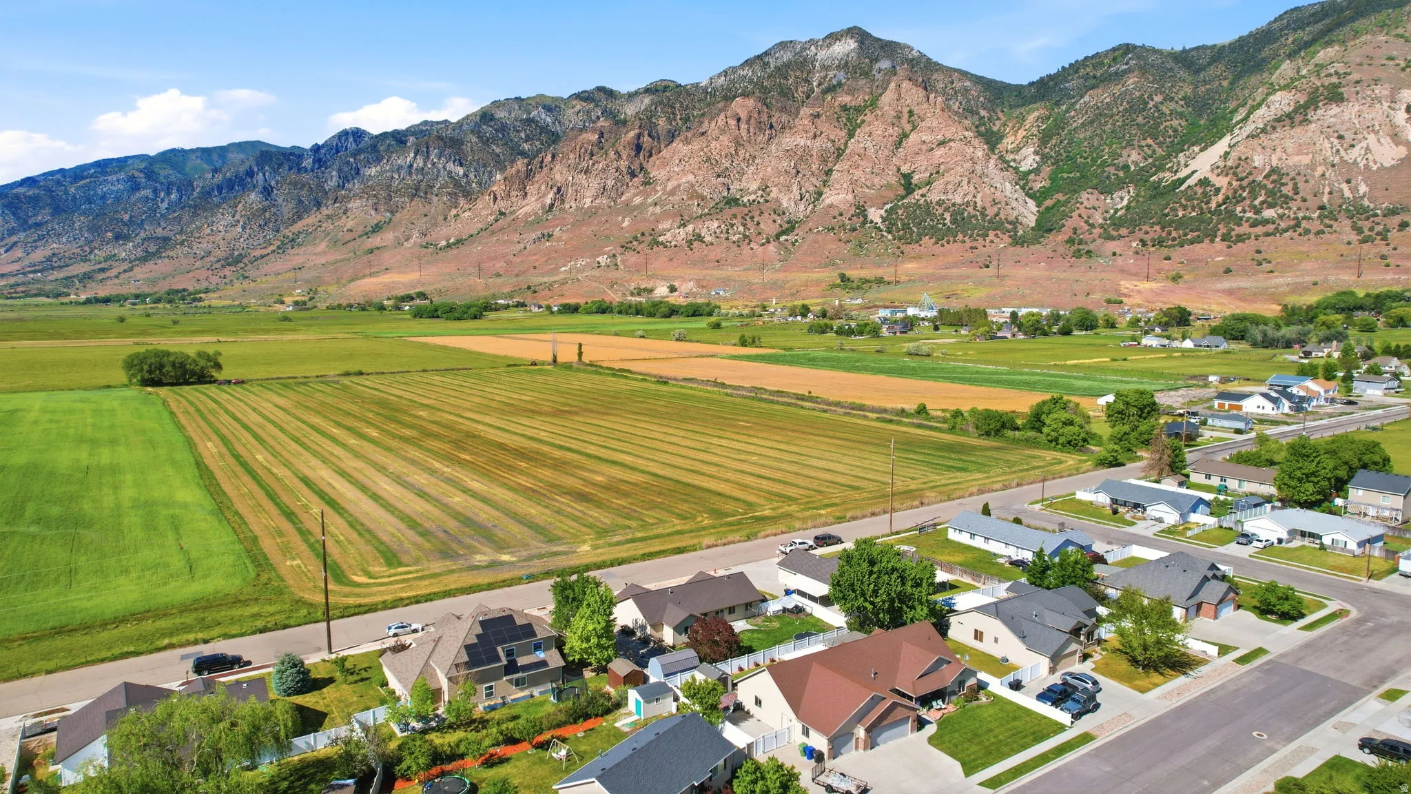 Expansive mountain range backdrop framing a residential area with varied housing styles