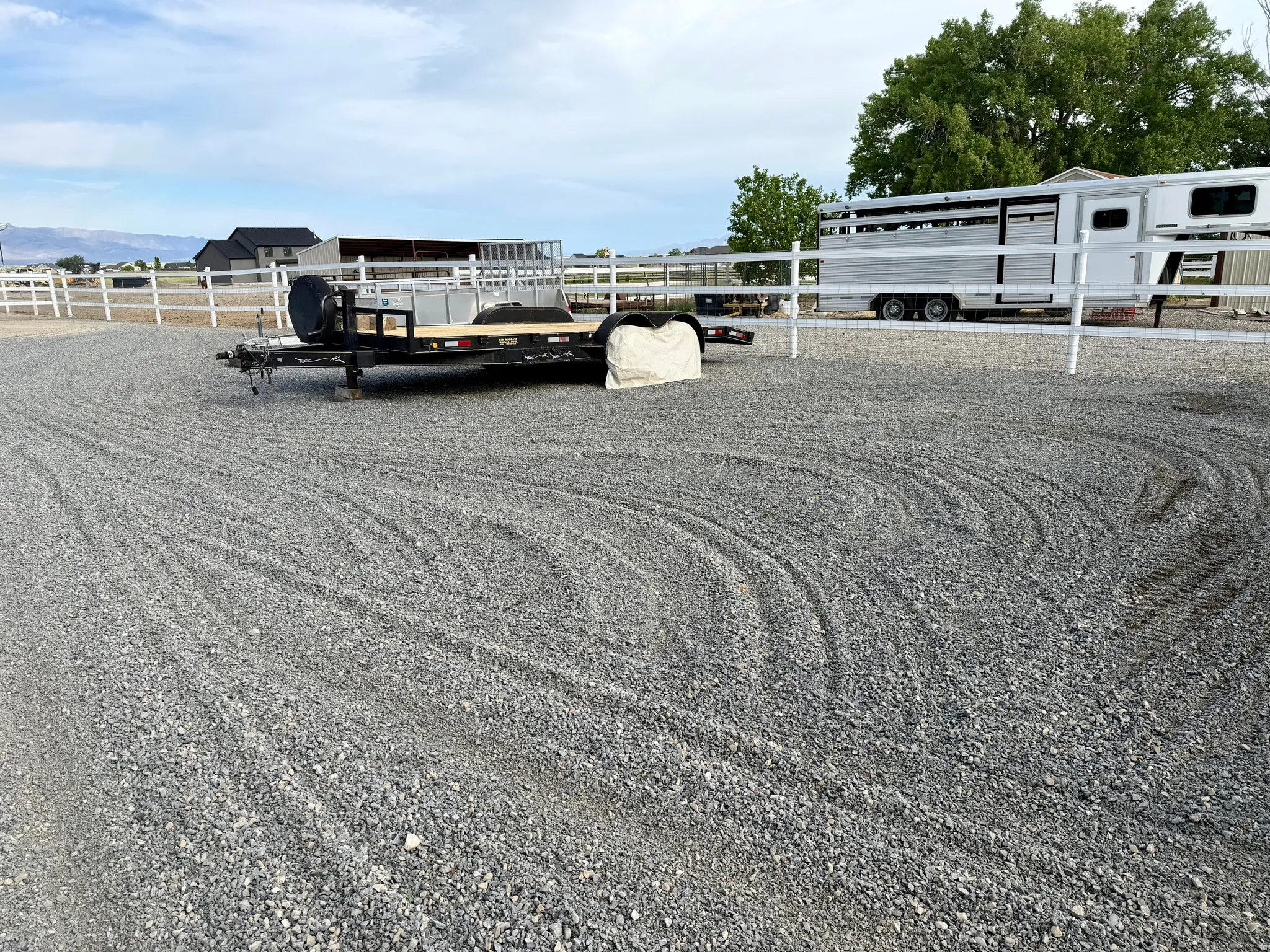 Gravel lot with white fencing
