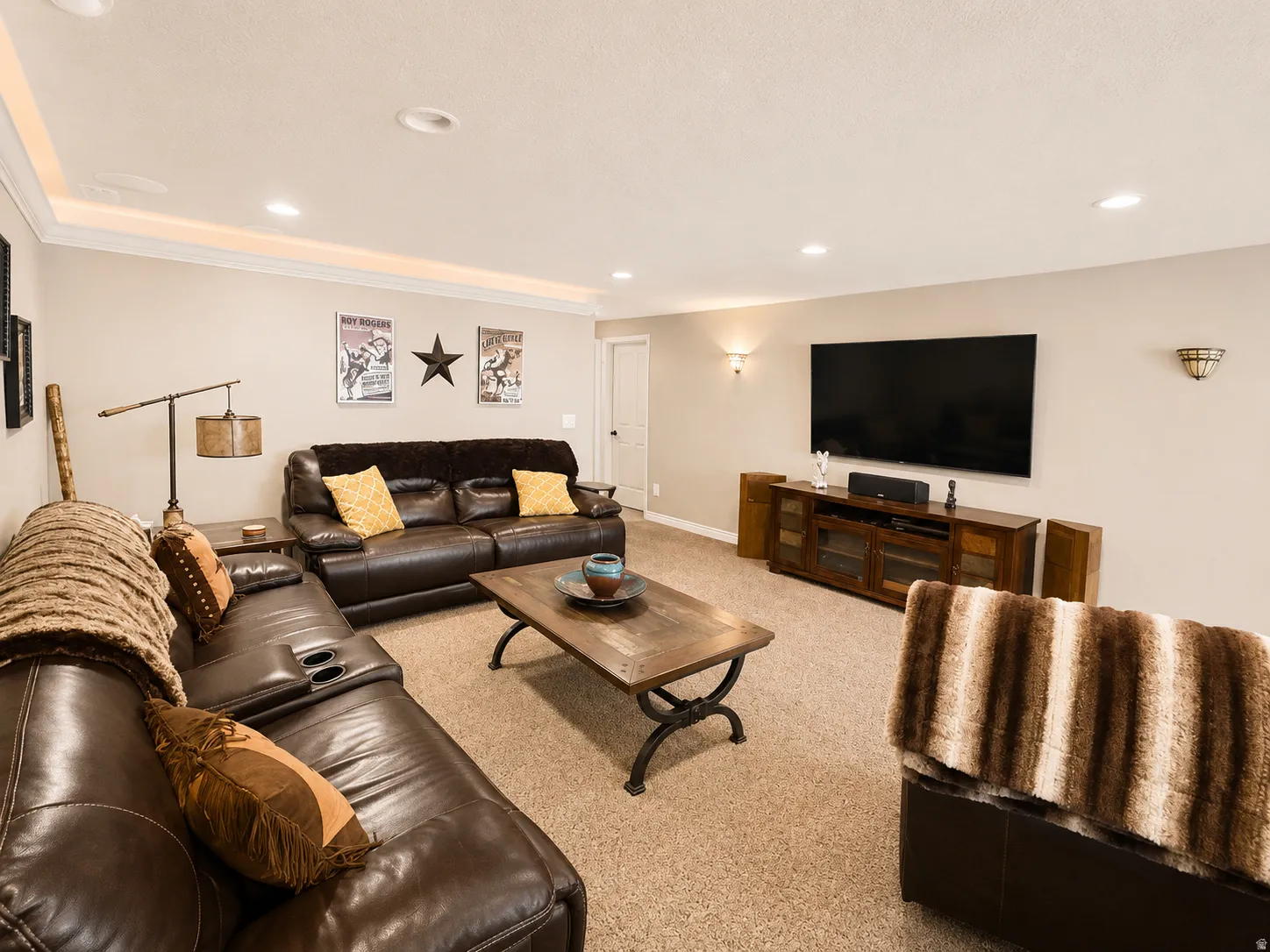 Recessed lighting throughout, crown molding with accent lighting, and wall sconces provide varied illumination