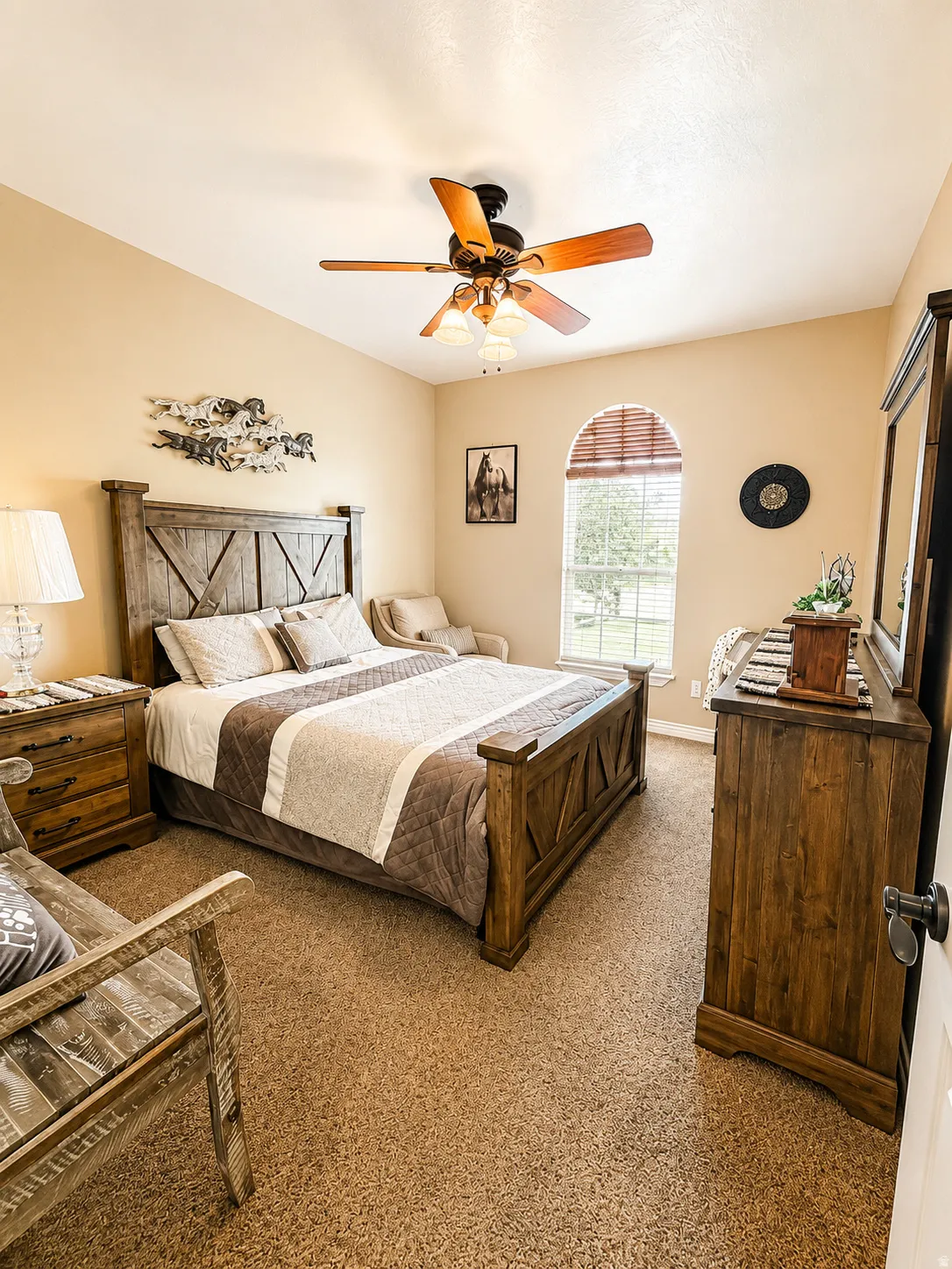 Carpeted bedroom featuring a vaulted ceiling and an arched window