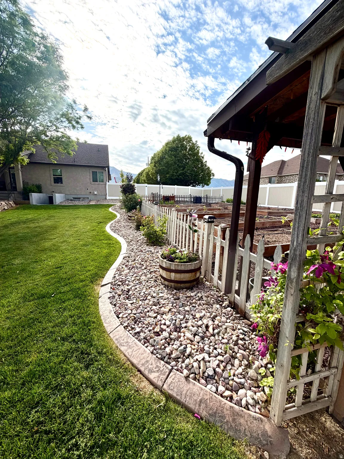 Manicured lawn with a decorative rock border and concrete edging