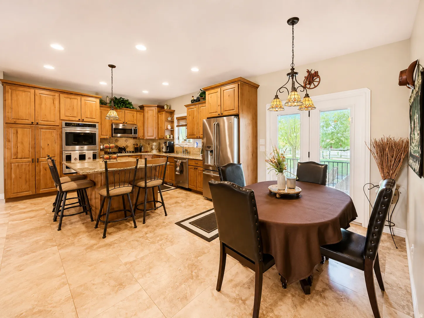 Kitchen and dining area featuring light-toned tile flooring throughout