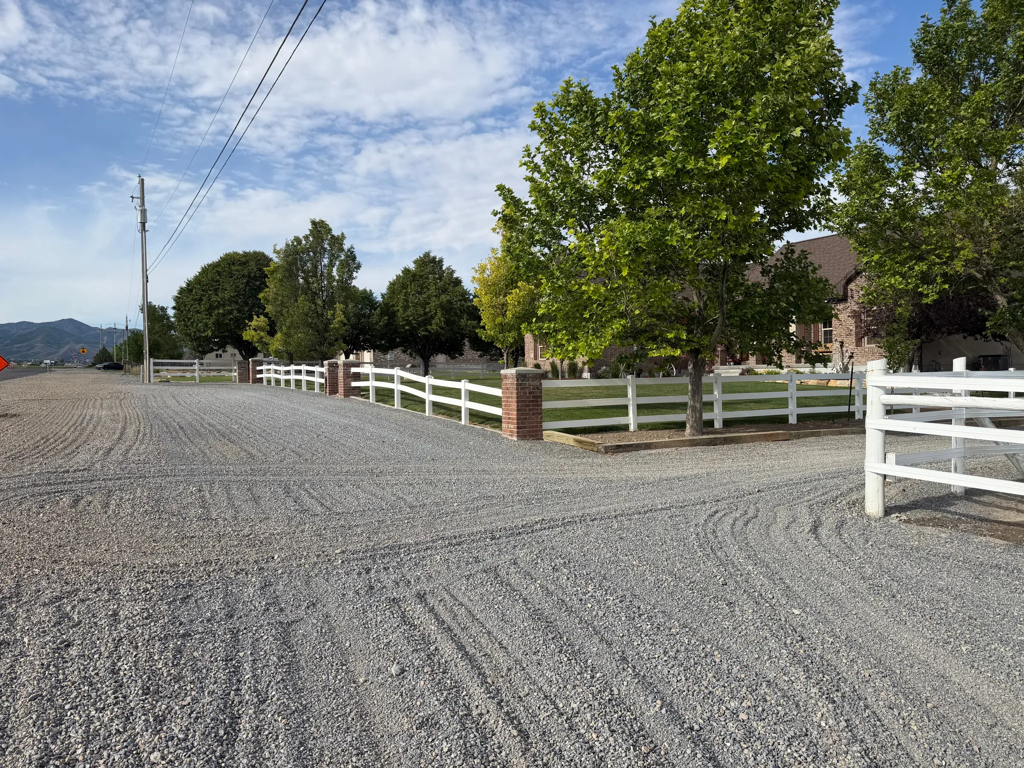 Expansive gravel driveway providing ample parking