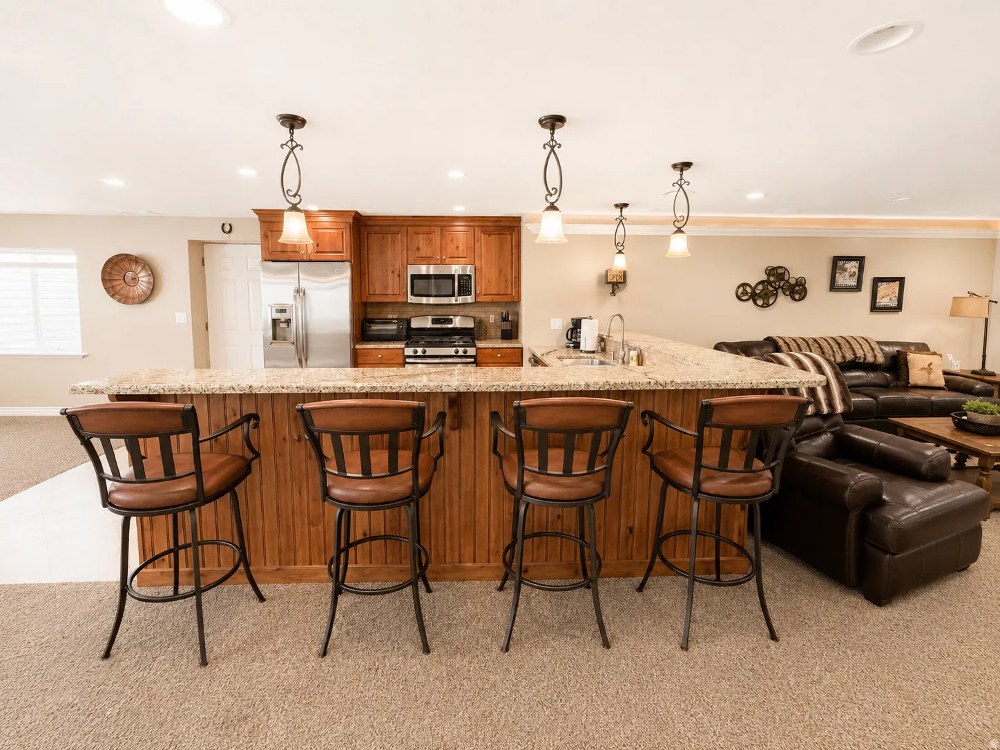 Kitchen island with a light granite countertop and beadboard paneling