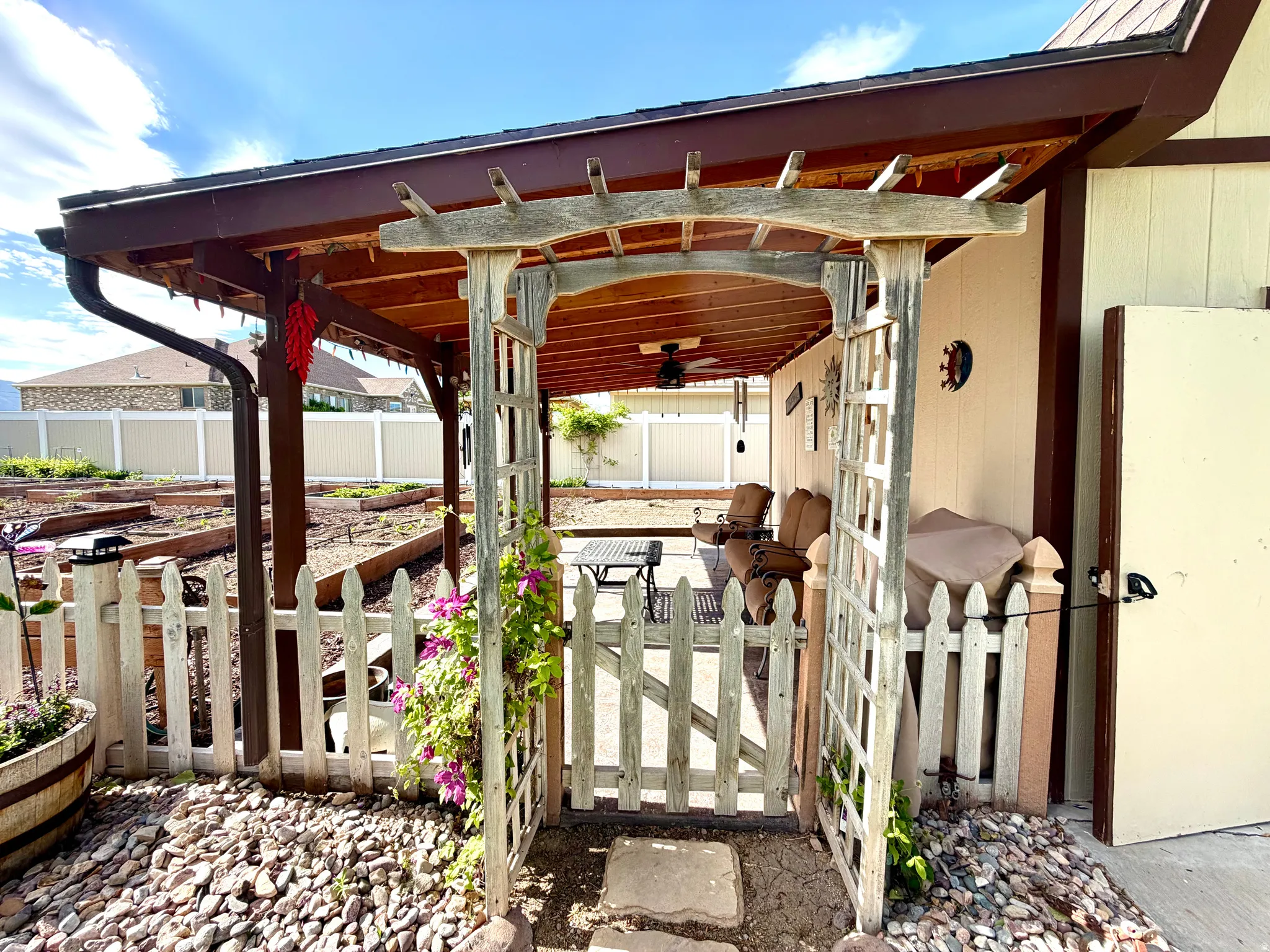 Covered patio area featuring a ceiling fan, concrete flooring, and a pergola entry