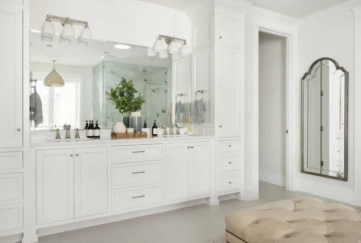 Dual vanity with white cabinetry, brushed nickel hardware, and a quartz countertop