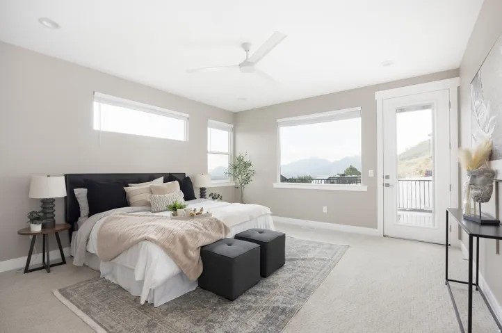 Spacious room featuring broad windows with mountain scenery, a glass-paneled exterior door, neutral-toned carpeting, and recessed ceiling lighting