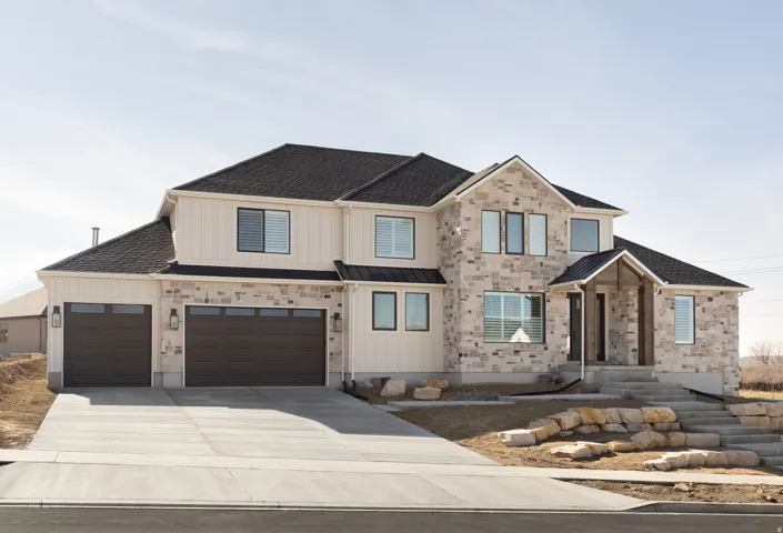 Contemporary two-story residence featuring a stone and vertical siding facade