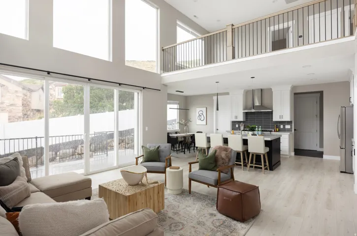 Open-concept living area with soaring ceilings and expansive windows