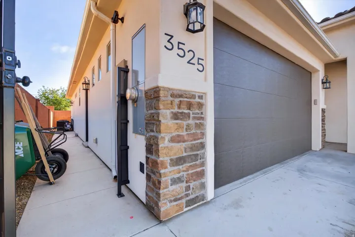 Modern garage door with horizontal paneling, complemented by a stone veneer accent