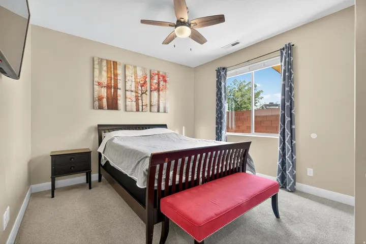 Neutral-toned walls complement the window with patterned drapes, offering natural light