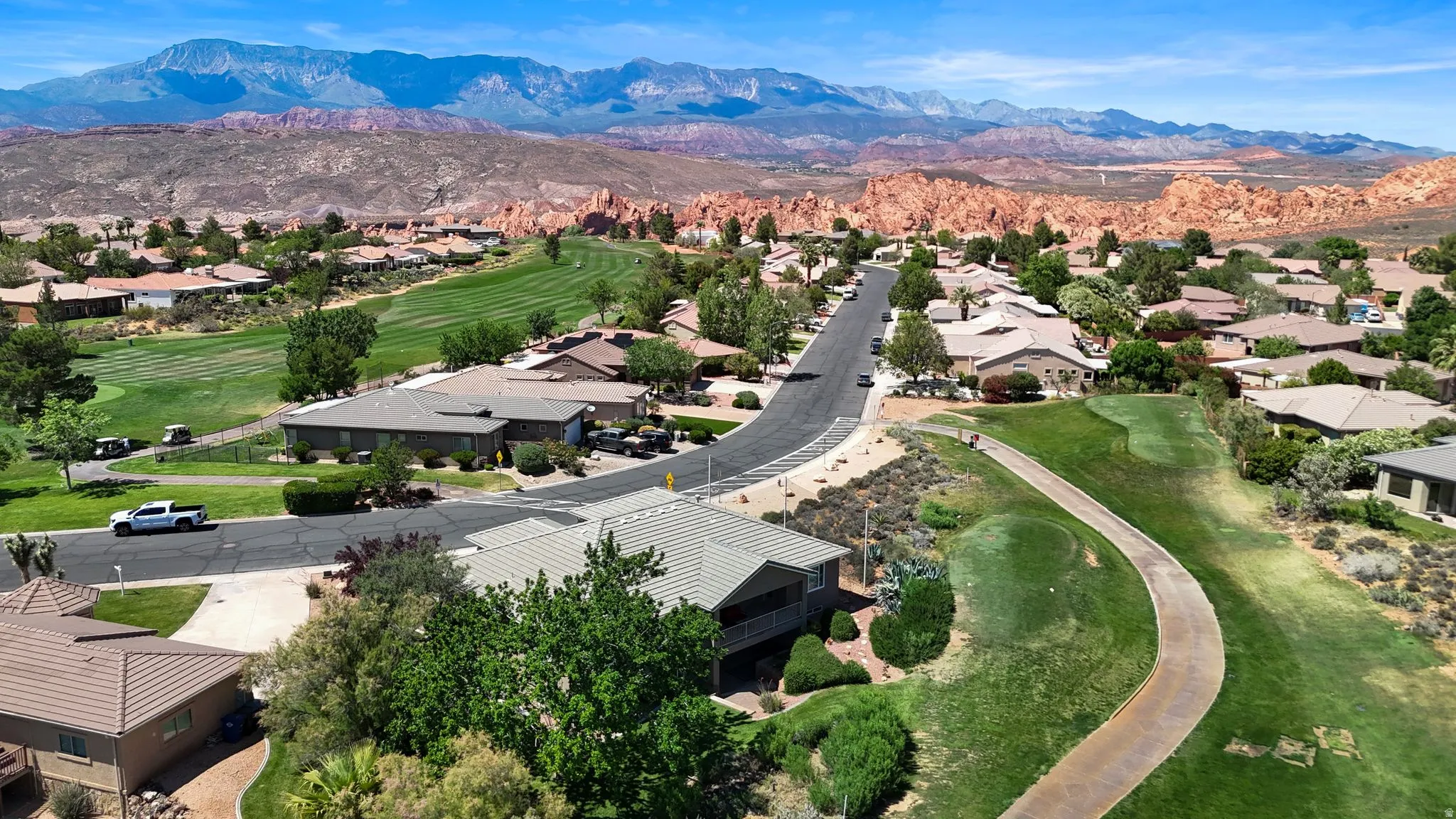 Aerial perspective showcasing a residential community with manicured golf course greens