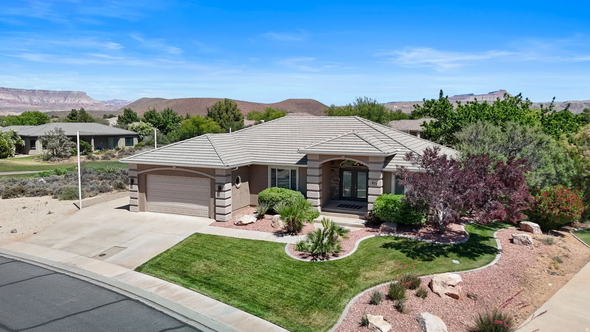 Single-story residence featuring a tiled roof and an attached two-car garage