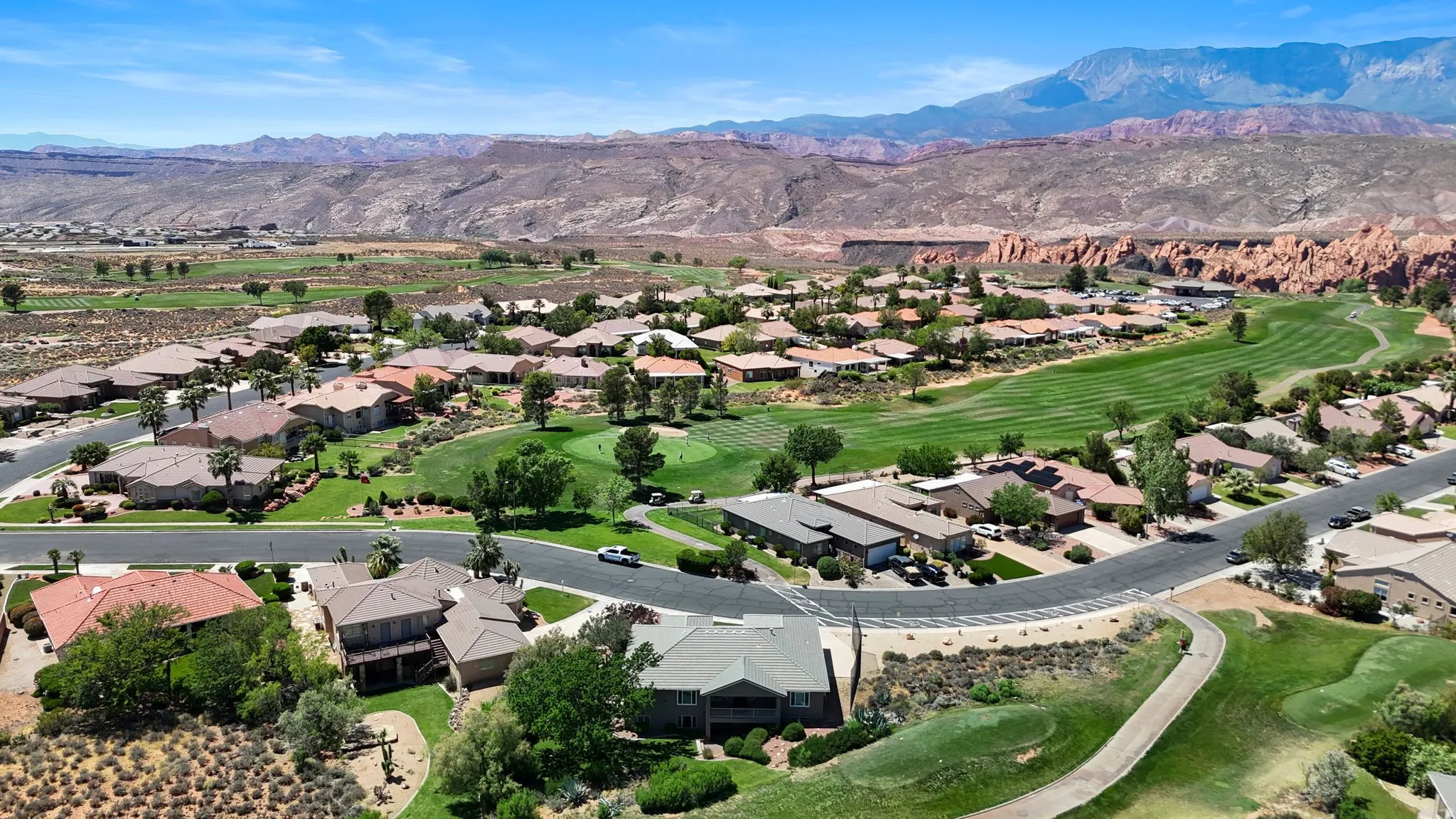 Community featuring a golf course, paved roads, and mature landscaping