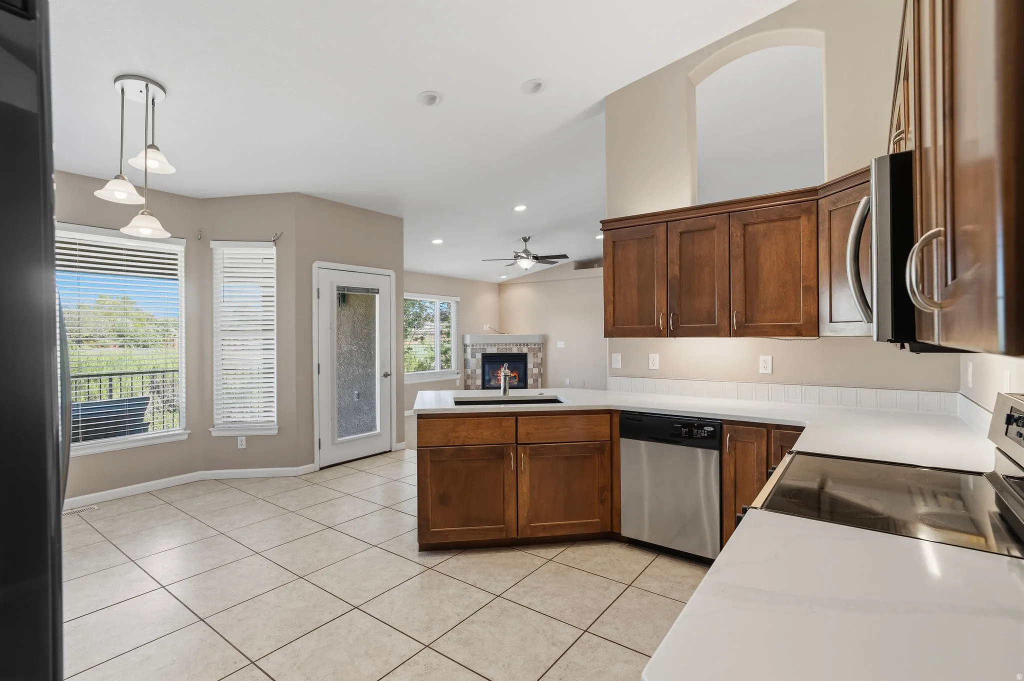 Kitchen featuring wood cabinetry, stainless steel appliances, and light-toned countertops