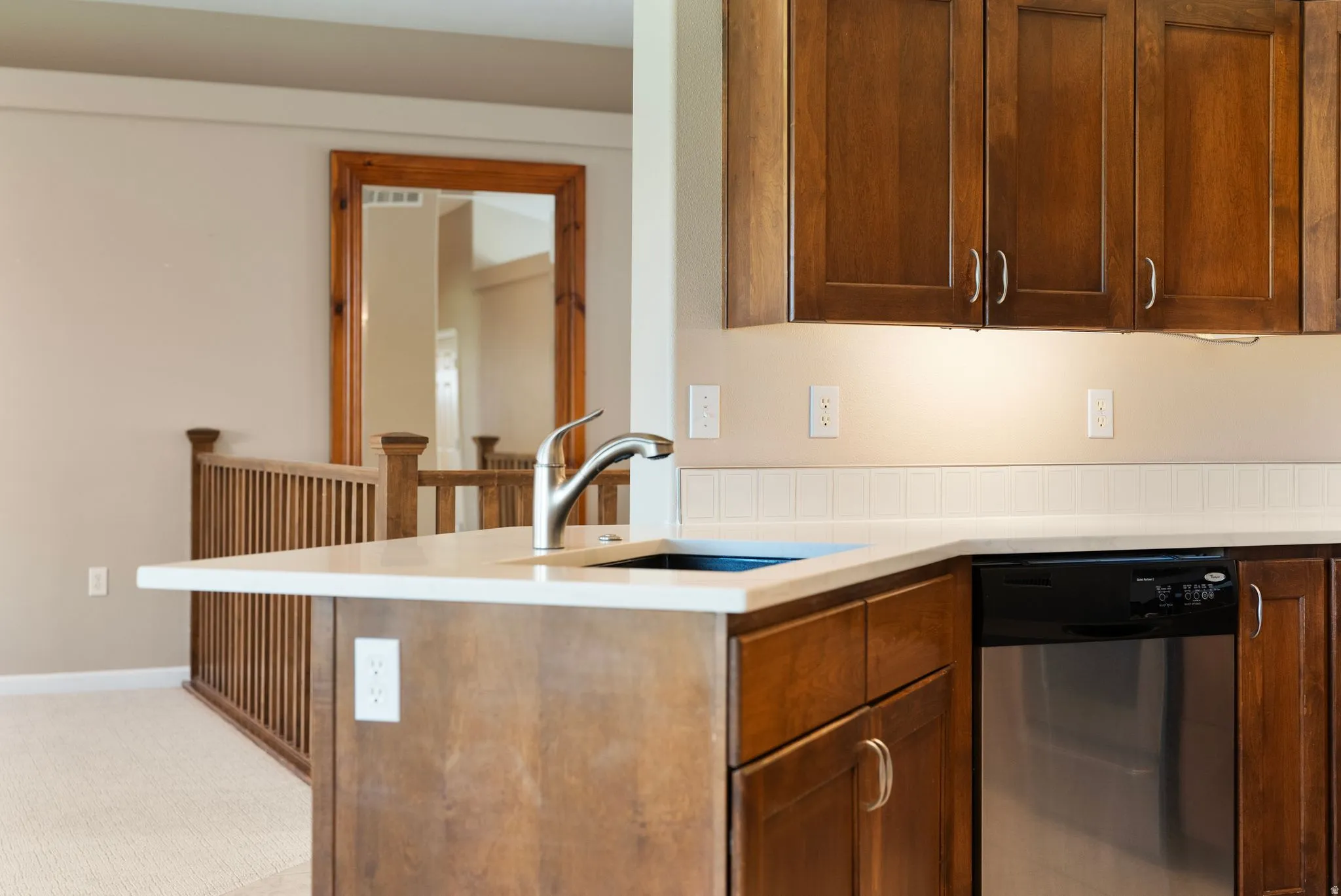 Kitchen island with a stainless steel sink and a modern faucet