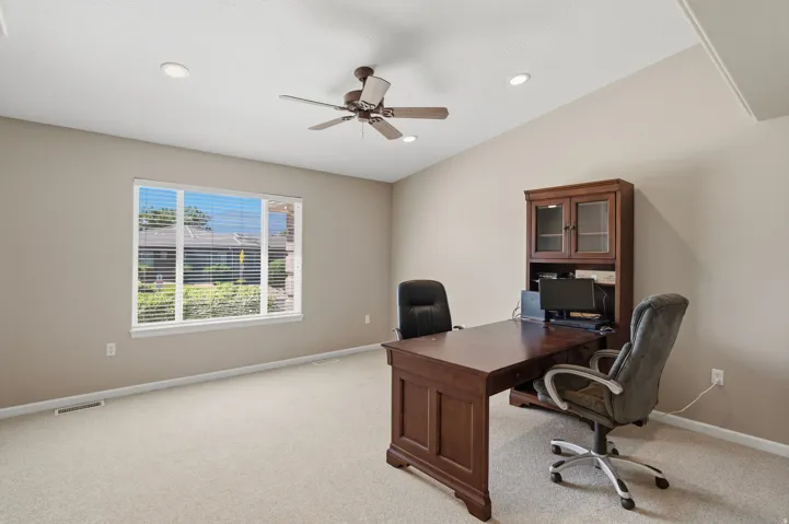 Spacious room featuring vaulted ceilings, recessed lighting, and a ceiling fan