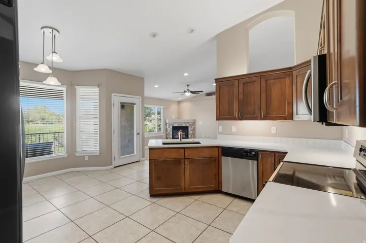 Kitchen featuring wood cabinetry, stainless steel appliances, and light-toned countertops
