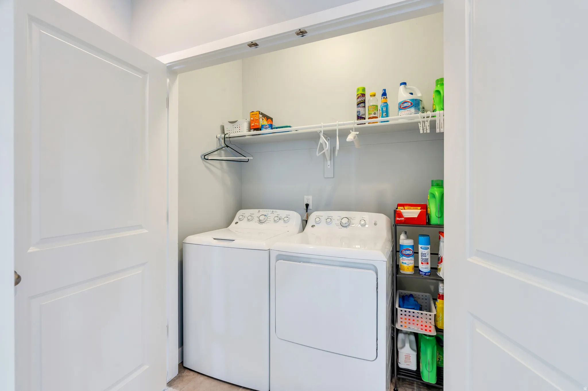 Dedicated laundry closet featuring a top-load washer and front-load dryer