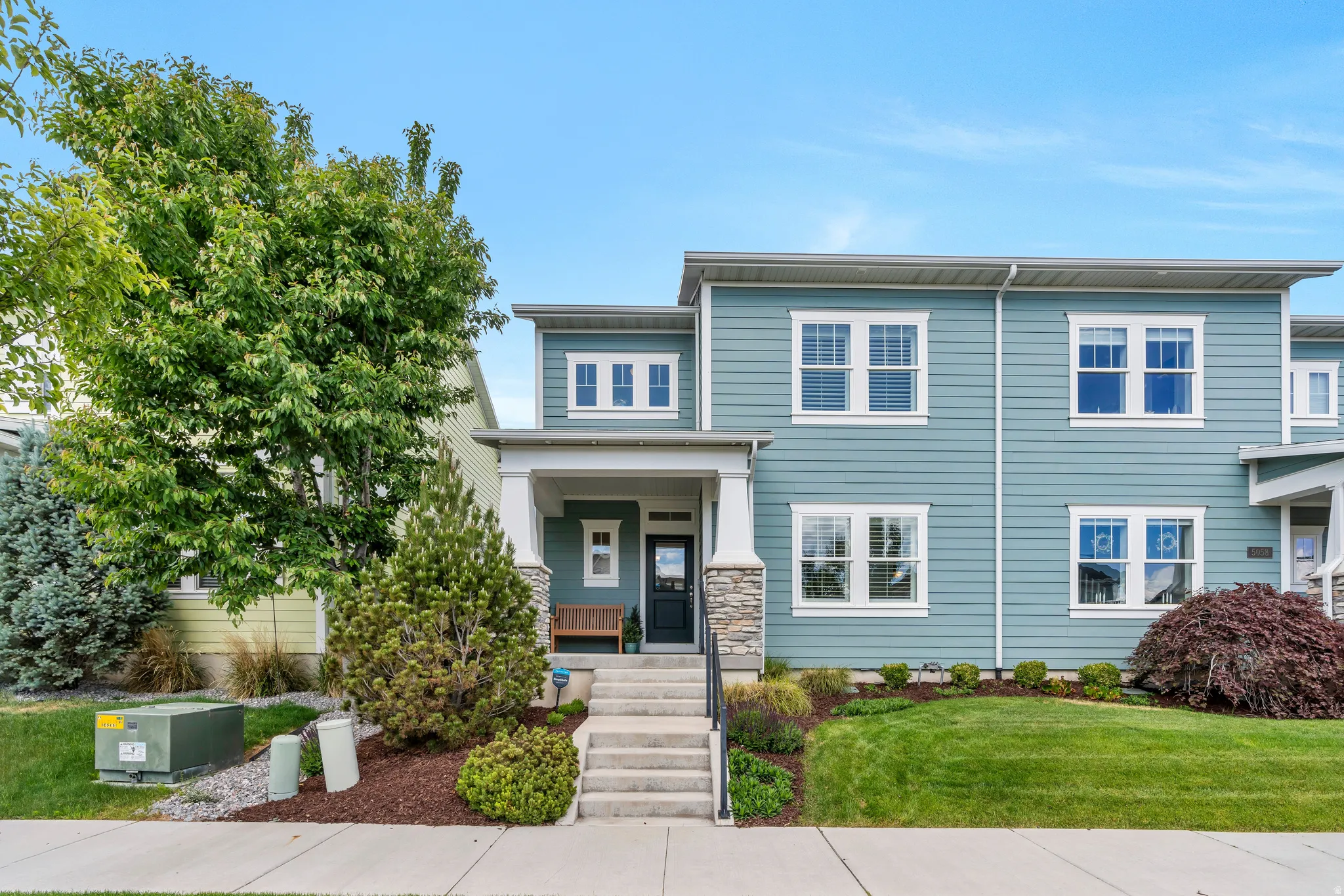 Contemporary townhome with blue siding and white trim
