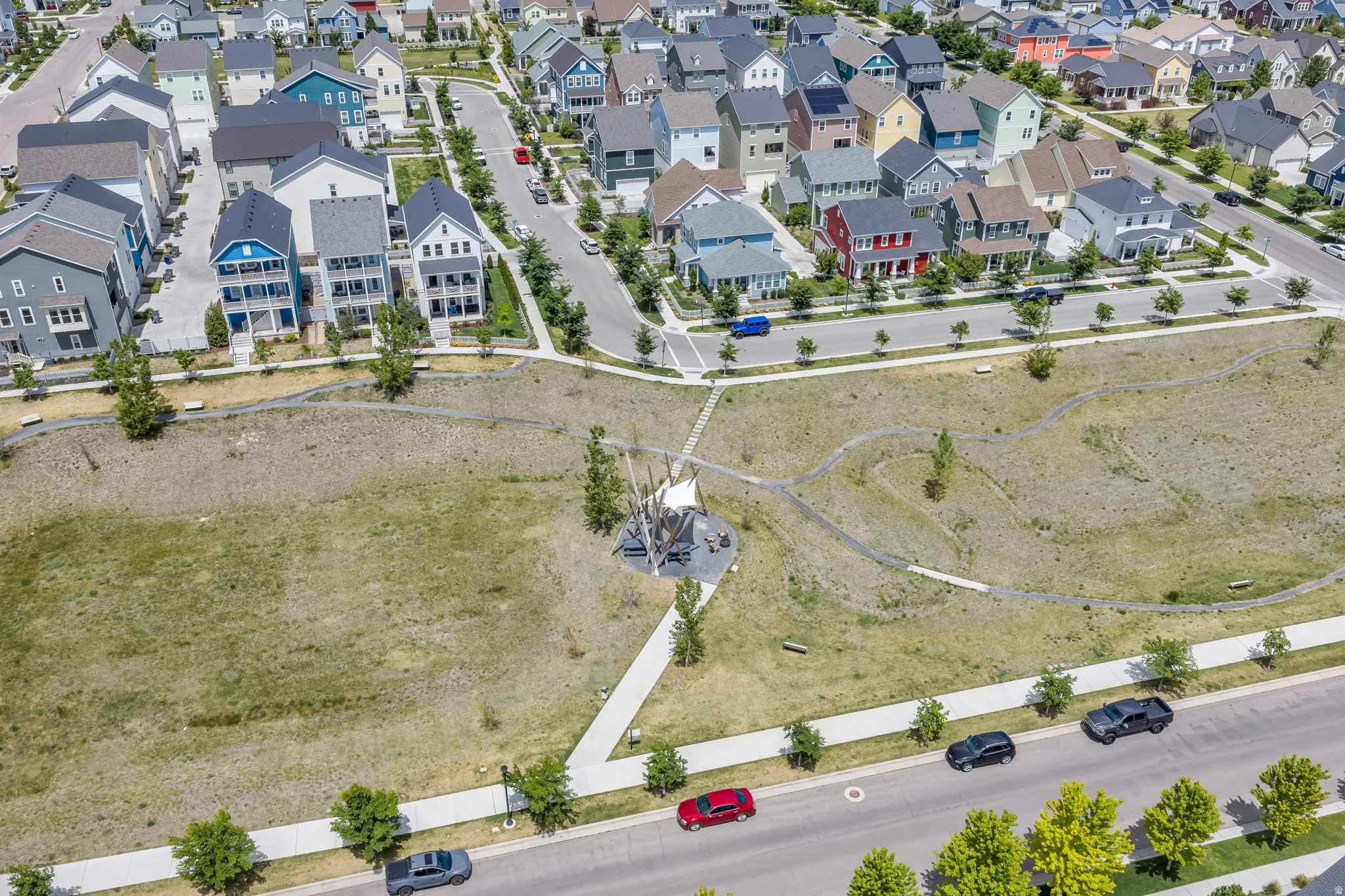 Expansive open space featuring walking paths and a contemporary art installation