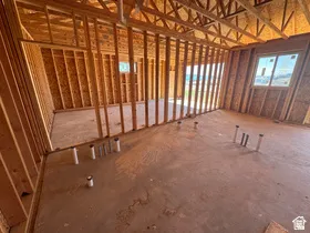 Interior framing featuring exposed wood studs, floor joists, and ceiling trusses
