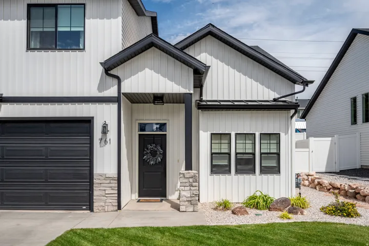 Contemporary exterior featuring white board and batten siding with contrasting black trim
