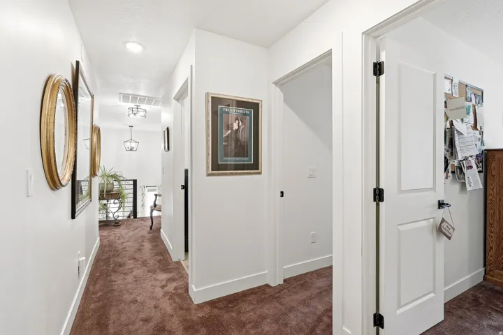 Hallway featuring light-toned walls, contrasting brown carpeting, recessed lighting, and white trim