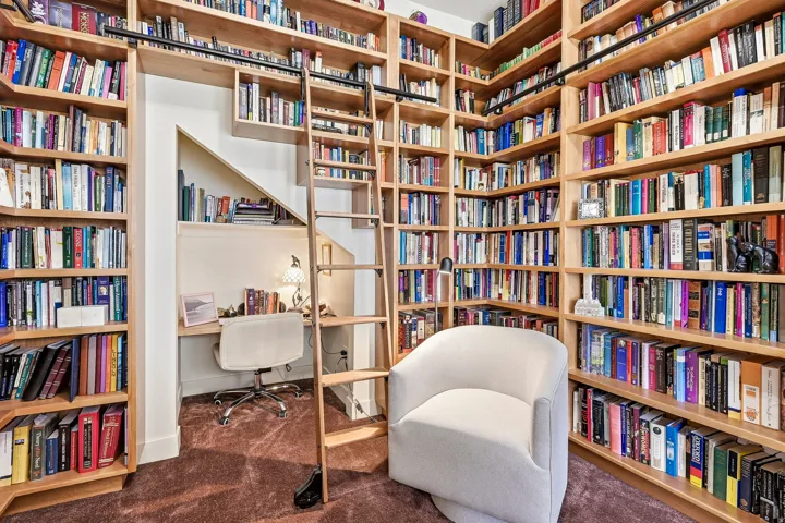 Custom built-in shelving with rolling ladder