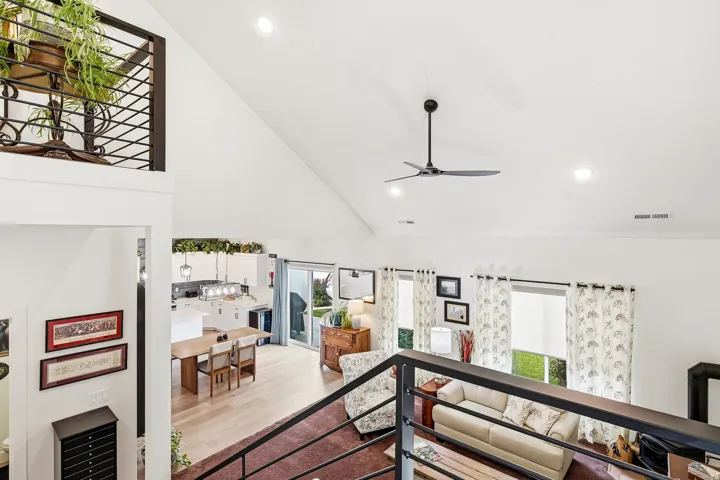 Vaulted ceiling with recessed lighting and ceiling fan