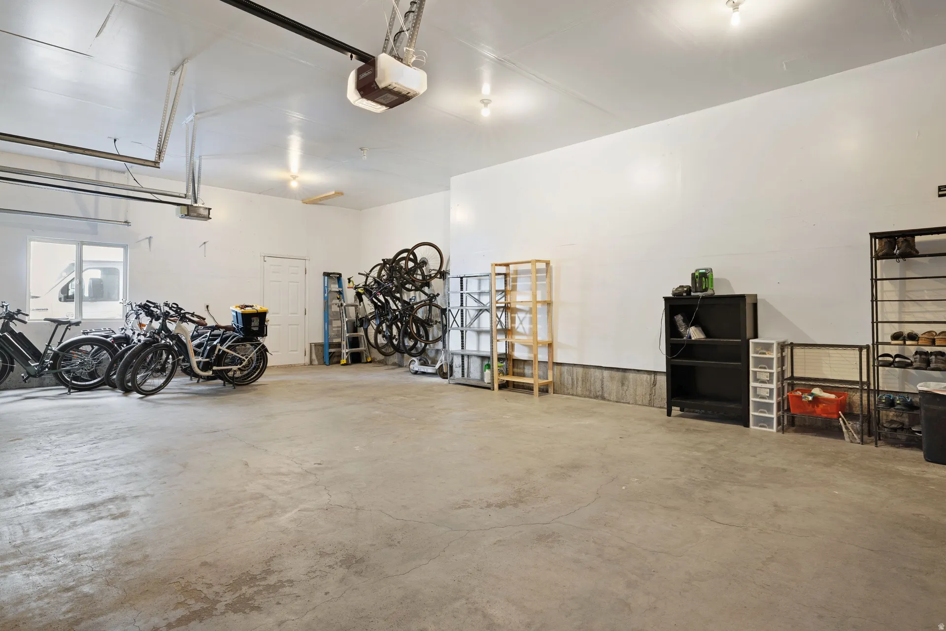 Spacious garage featuring a concrete floor, white painted walls, and overhead lighting
