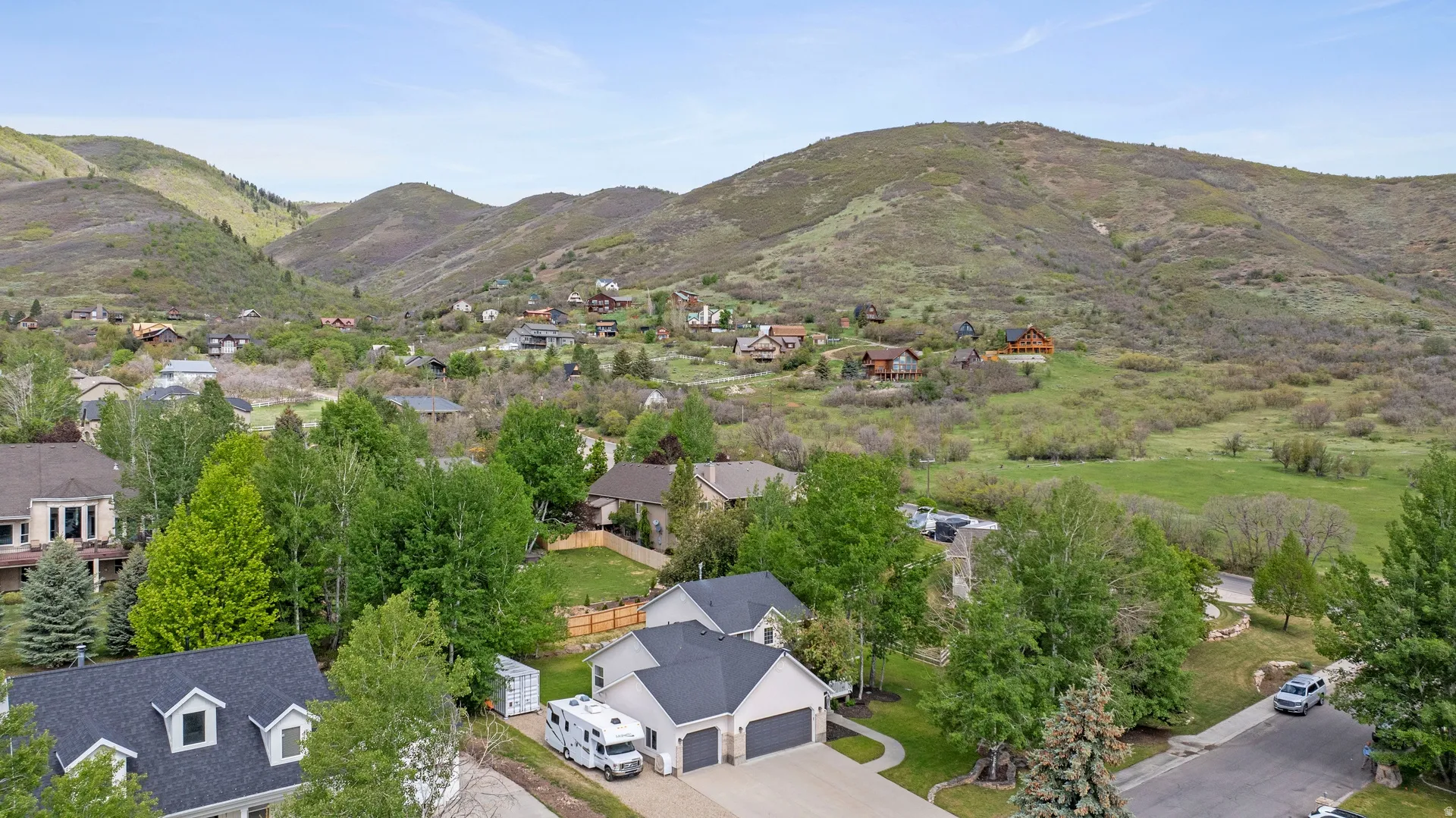 Aerial perspective showcasing a residential community nestled within a mountainous landscape
