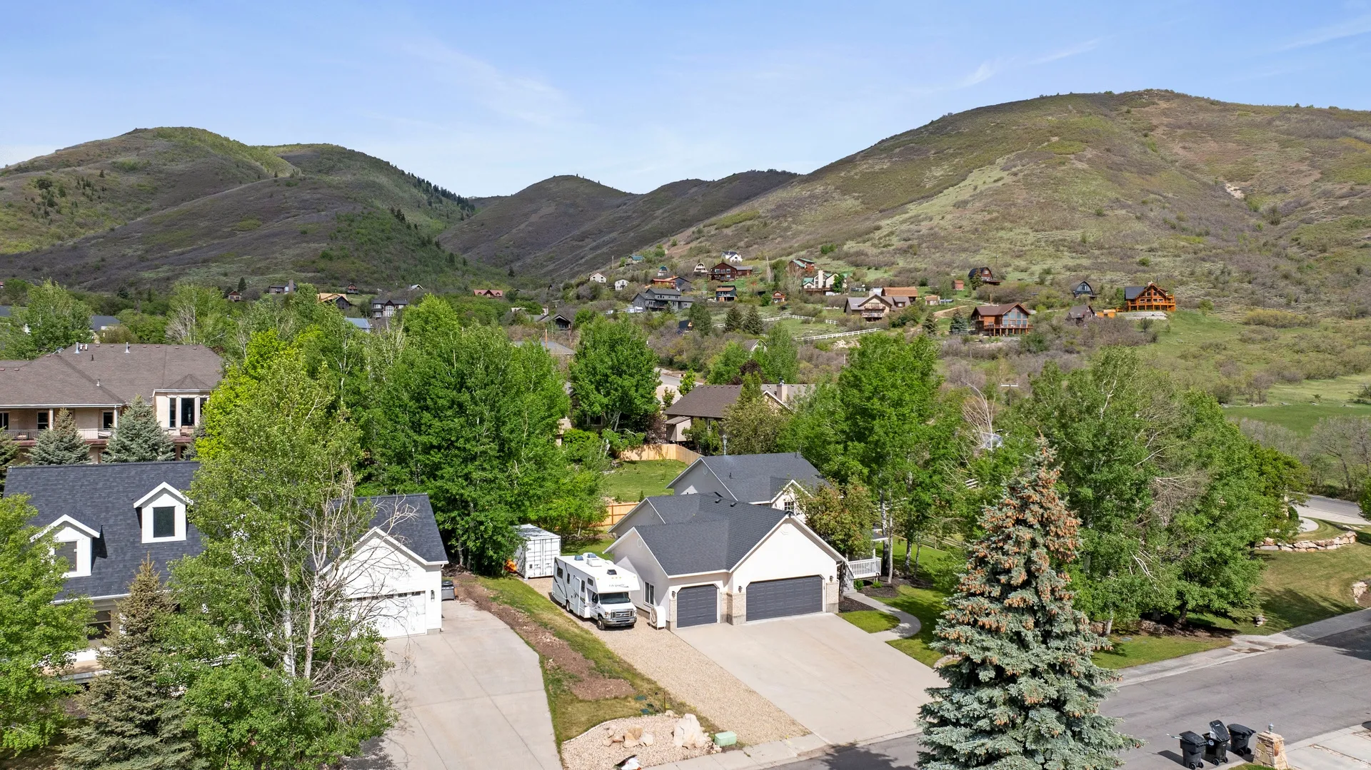 Suburban residential area with green, tree-covered hillsides