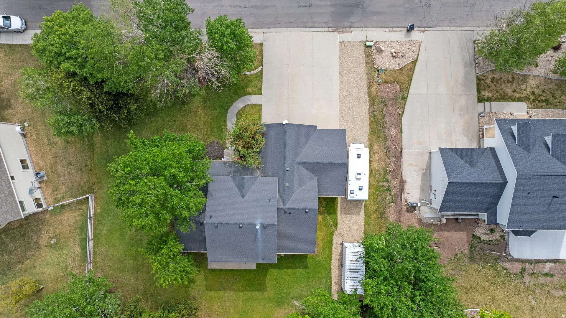 Expansive asphalt driveway with concrete entry