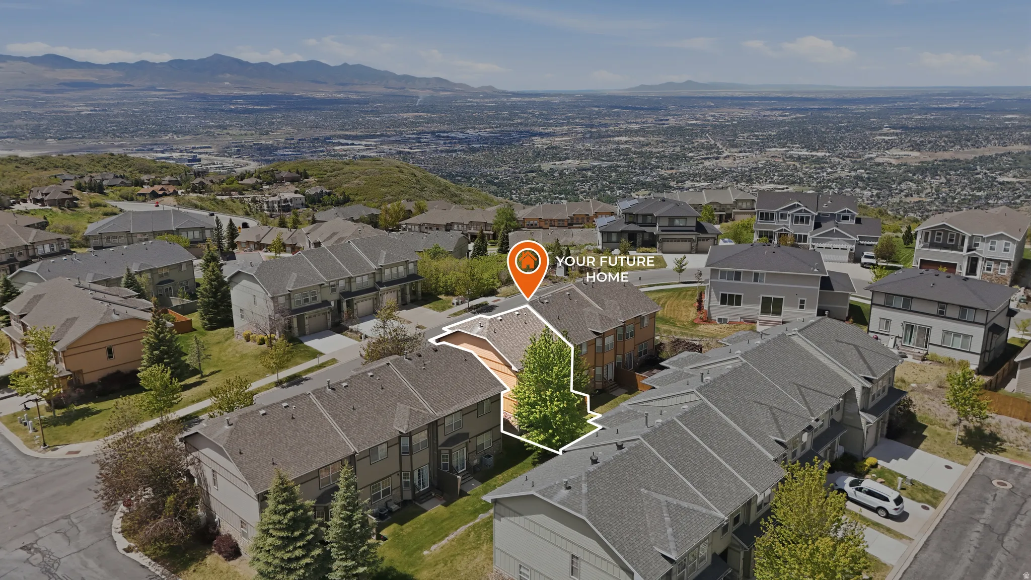Aerial perspective showcasing a residential area with a prominent mountain backdrop