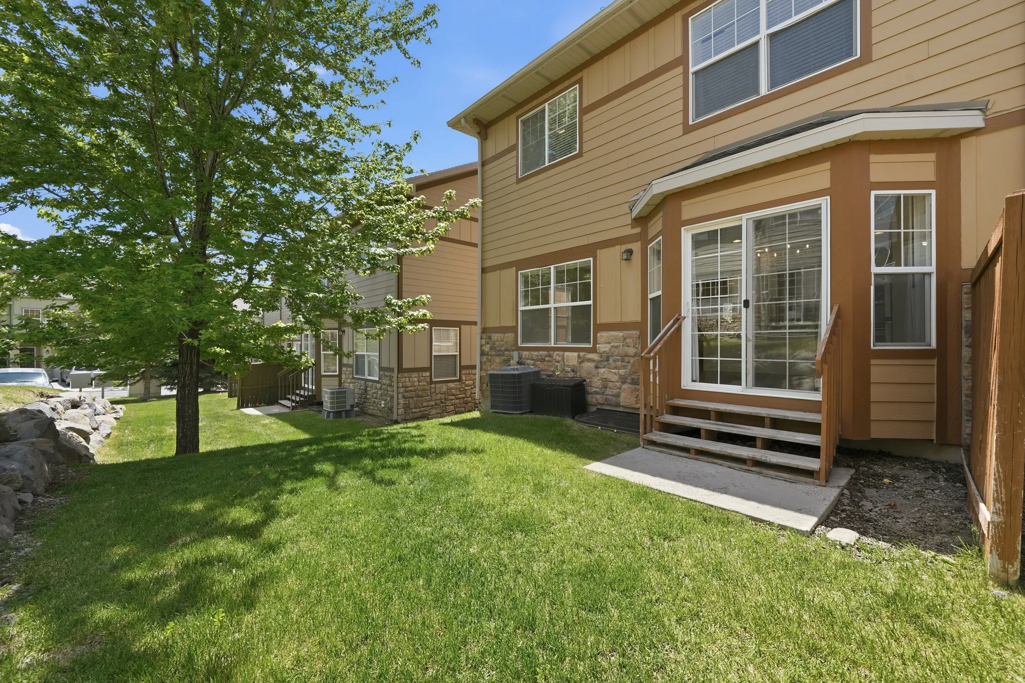 Rear exterior with sliding glass door access to the yard