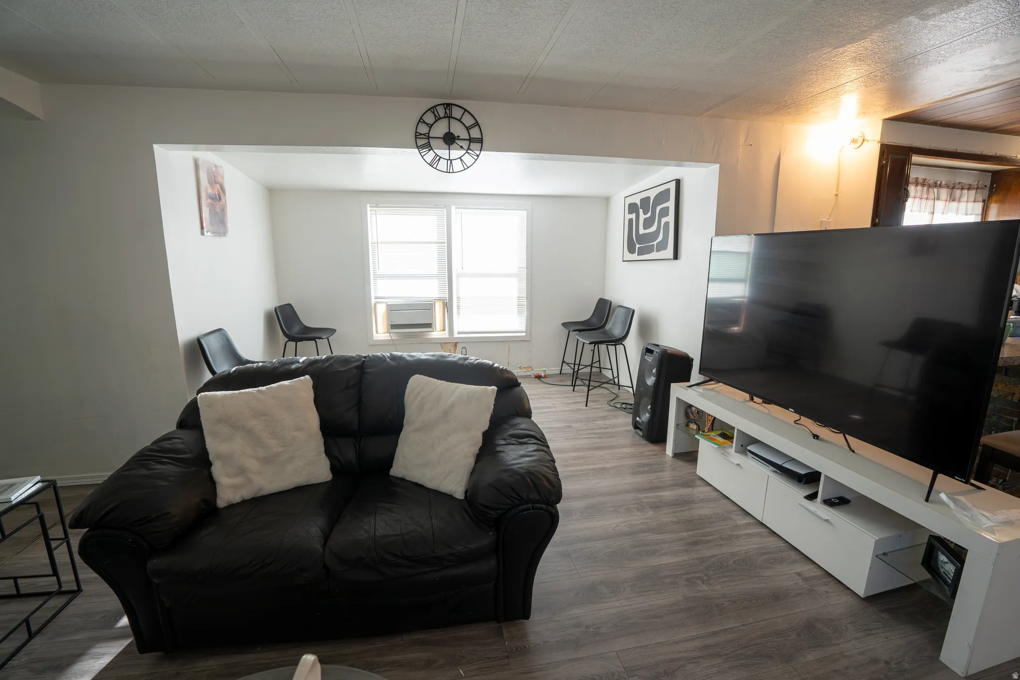 Open-concept living space with wood-finish flooring