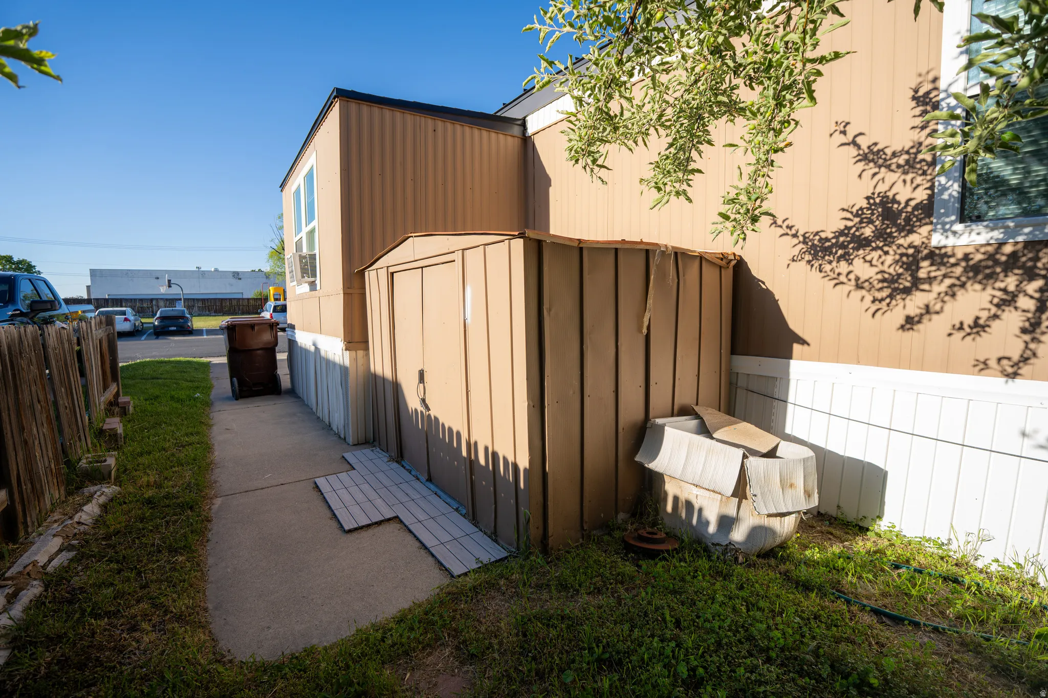 Exterior siding in a neutral tone with white skirting