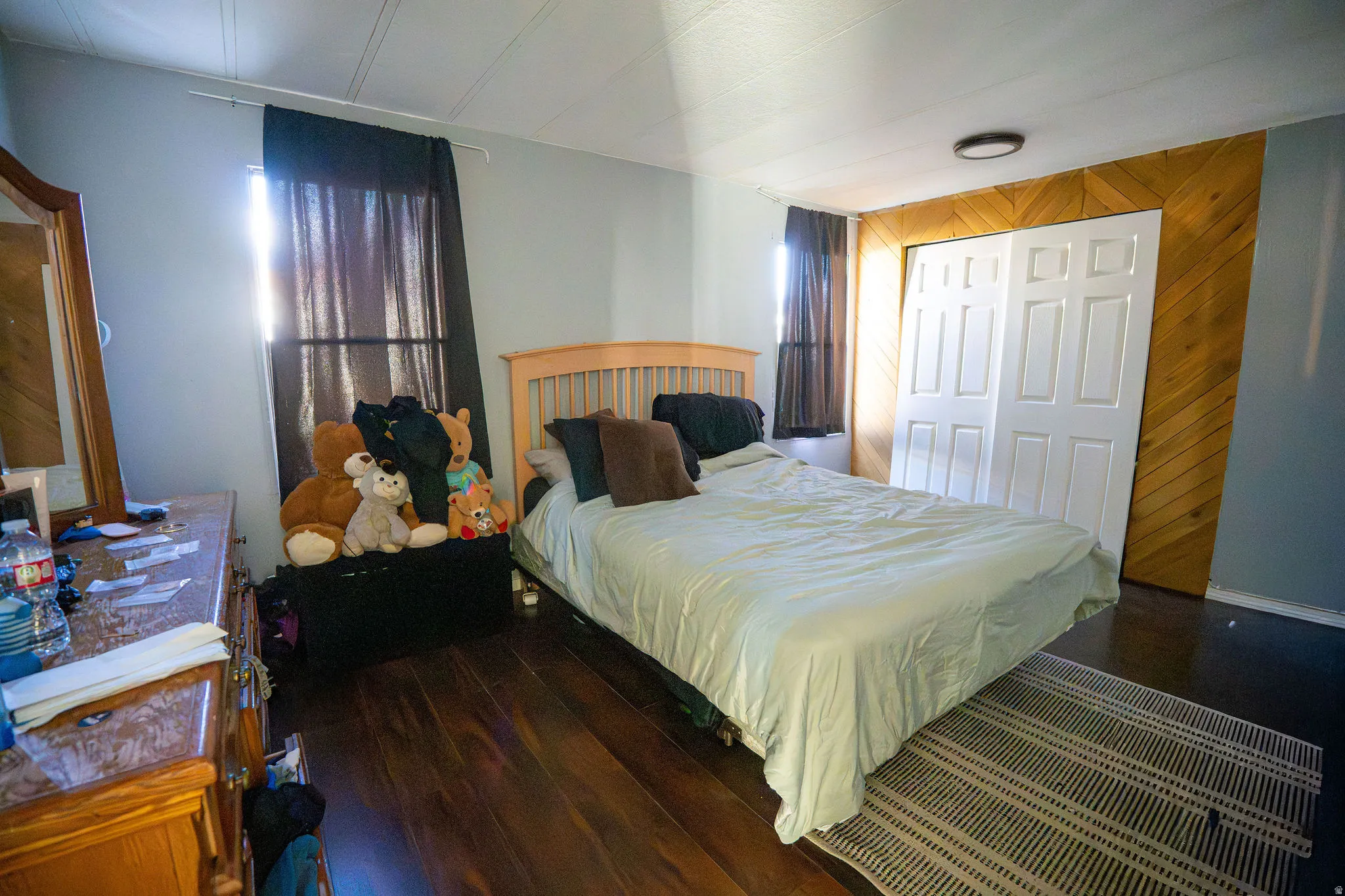 Interior room featuring wood-finish flooring, light gray wall paint, and a textured ceiling