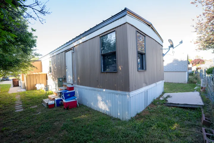 Single-story residence featuring brown siding and white skirting