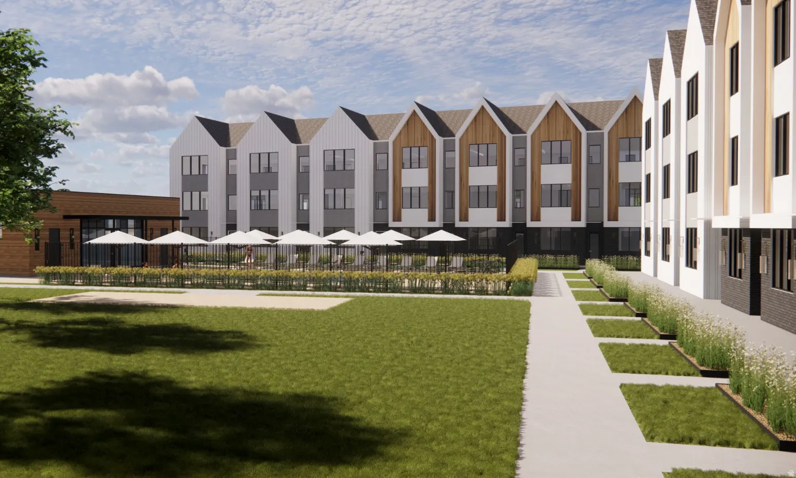 Contemporary multi-story buildings featuring gabled rooflines and a mix of vertical siding and wood-finish paneling