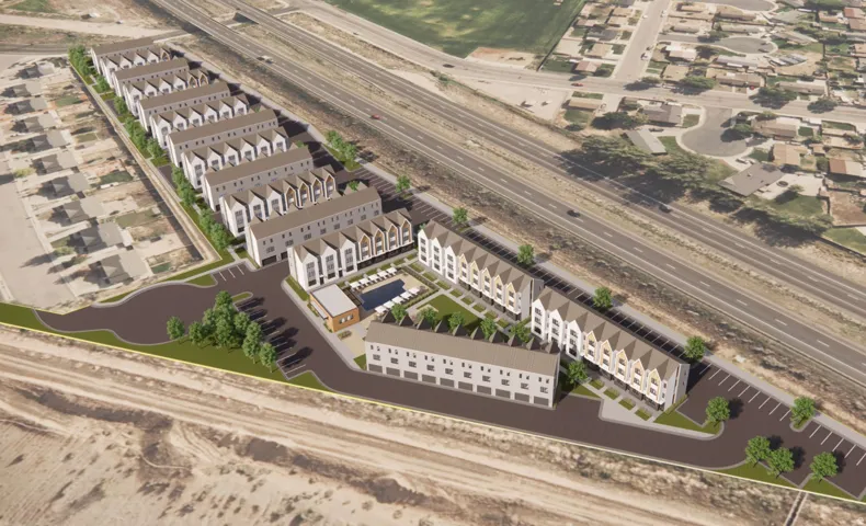 Expansive development showcasing multiple rows of townhomes with pitched roofs and white facades