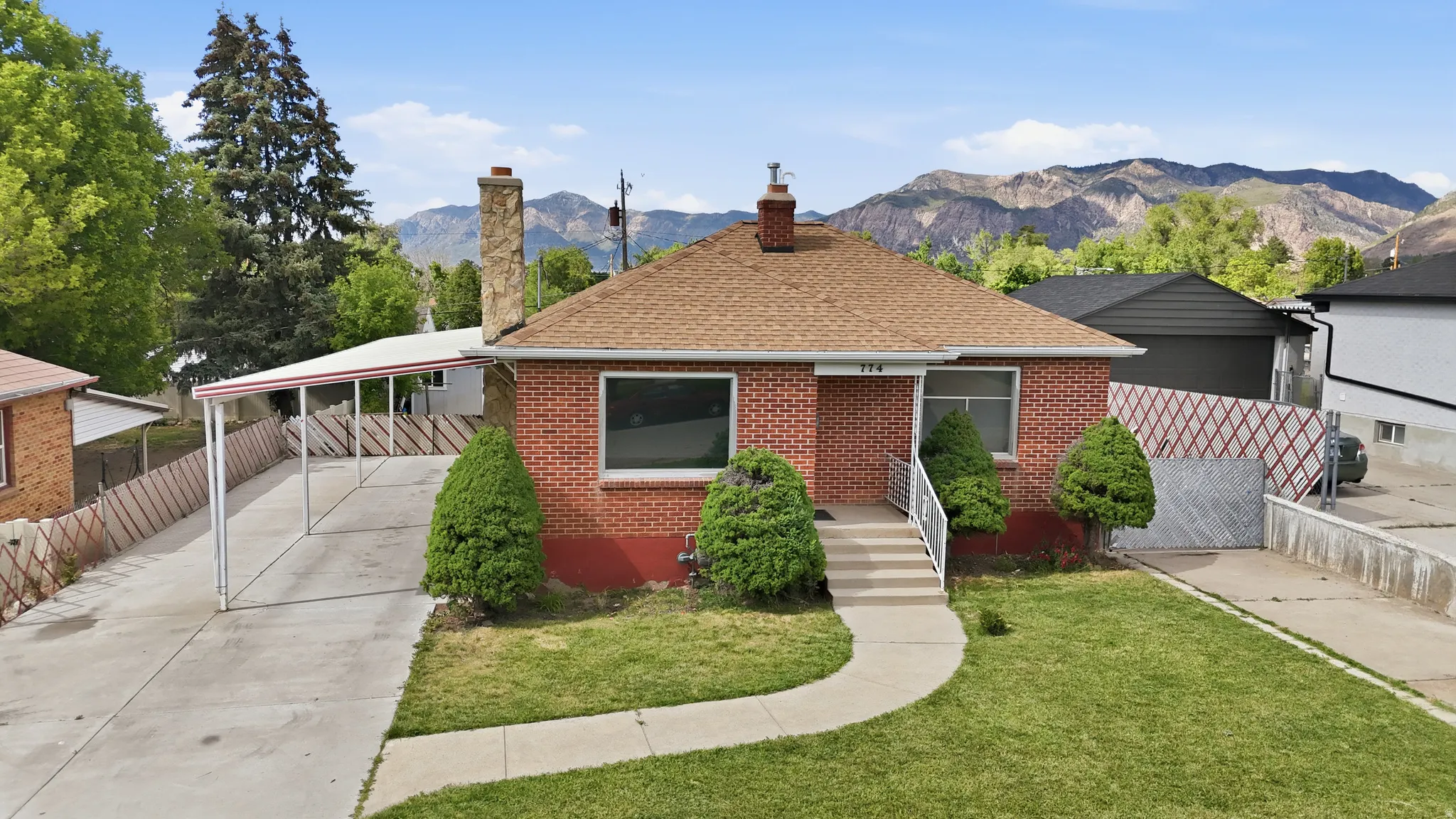 Brick exterior residence with a shingle roof